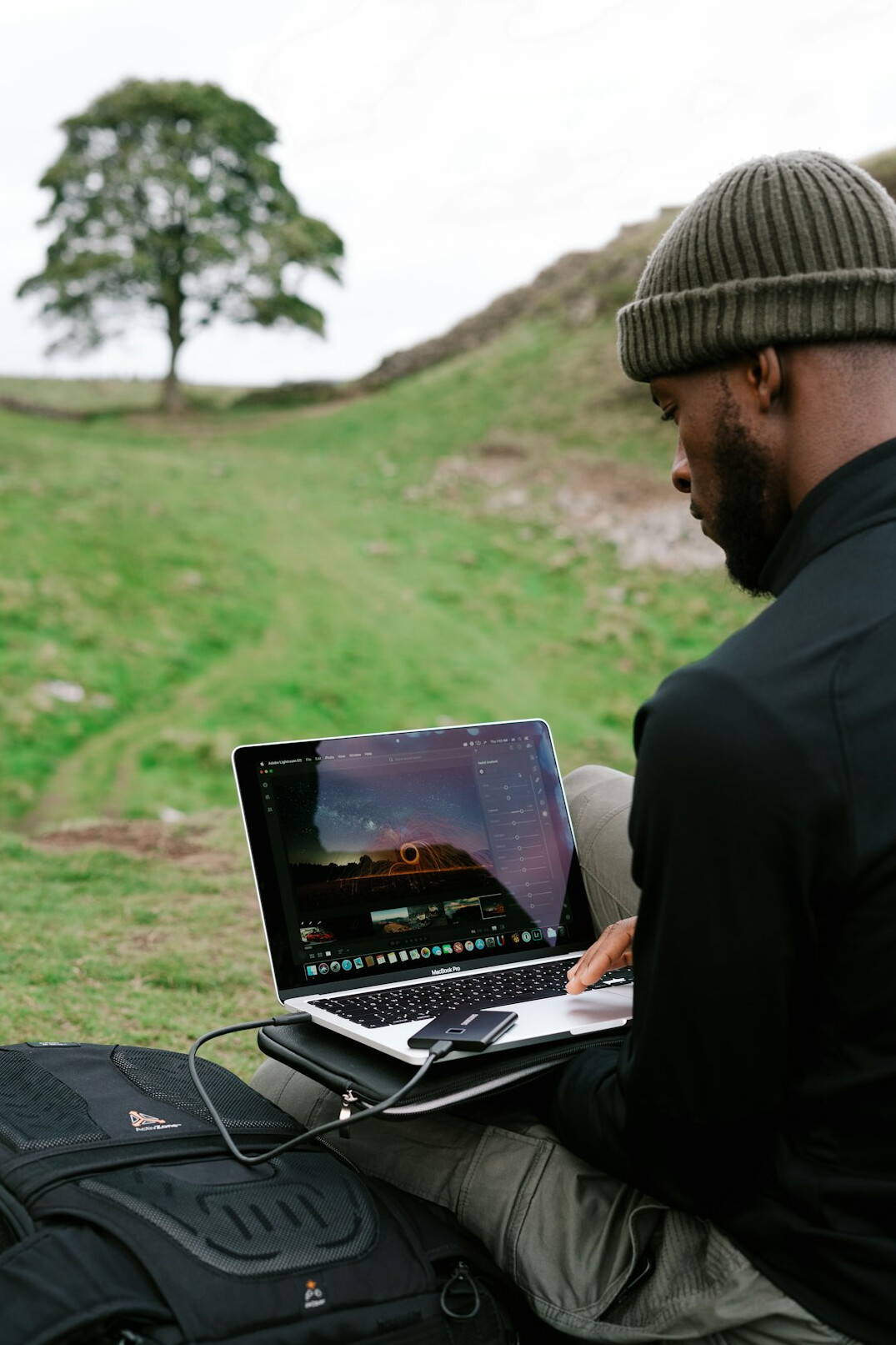 person using laptop in nature